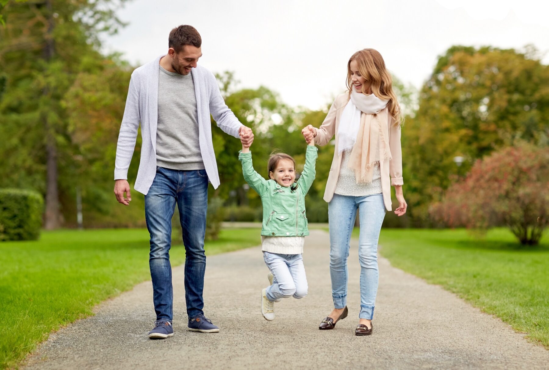 Young couple with their daughter on a walk