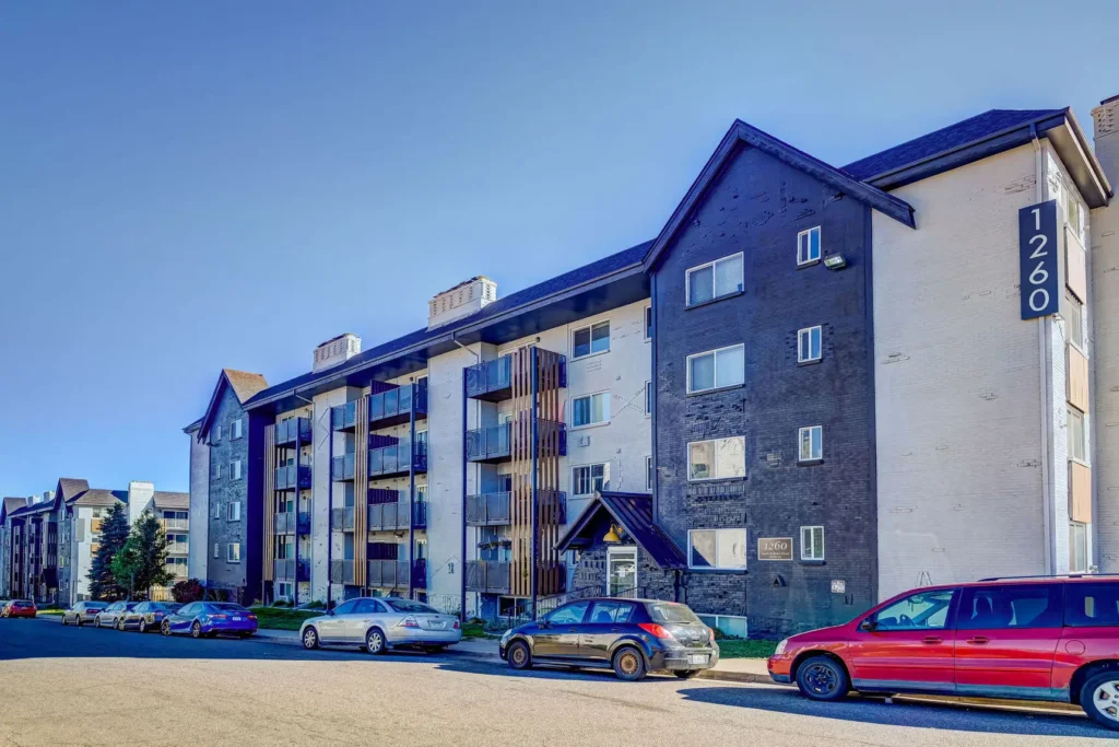 Building exterior with cars parked on the street